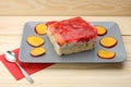 Strawberry and peach cake with gelatin on grey plate on wooden t Royalty Free Stock Photo