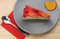 Strawberry and peach cake with gelatin on grey plate on wooden t Royalty Free Stock Photo