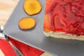 Strawberry and peach cake with gelatin on grey plate on wooden t Royalty Free Stock Photo