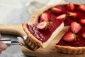 Strawberry pie with fresh berries. Cake shovel with piece of pie on blurred background. Sweet summer dessert Royalty Free Stock Photo