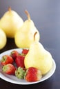 Strawberry in plate and pear Royalty Free Stock Photo