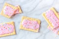 Strawberry pop tarts, shot from the top on a marble background Royalty Free Stock Photo