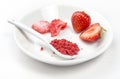 Strawberry powder made of freeze dried strawberries for sprinkle. Flavor and color ingredient for food. Top view  white minimal ba Royalty Free Stock Photo