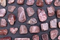 Strawberry quartz rare stones texture on black stone background