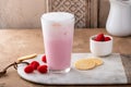 Strawberry milk drink with cold foam in a tall glass