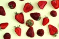 Texture strawberry slices on a light yellow background. Ripe fresh strawberry berries close-up. View from above