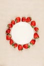 Strawberry round frame and empty white plate on craft paper background, top view, flat lay Berries mockup. Frame made of fresh Royalty Free Stock Photo