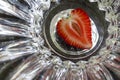 Strawberry sectioned in half in the shape of heart on abstract background