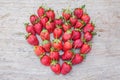 Strawberry shape heart on dry wood