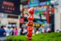 Strawberry skewers in crispy caramel, street food in Beijing, China