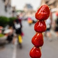 Strawberry skewers in crispy caramel, street food in Beijing, China