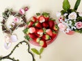 Strawberry and slices on white background ,flowers in red cup ,and ,branch in heart shape still life