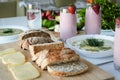 Strawberry smoothie, broccoli soup, fresh vegetables and berries, cheese and bread on wooden board on white background Royalty Free Stock Photo