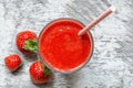 Strawberry smoothie in a glass with fresh berries and straw on white wooden background. Top view. Healthy summer Royalty Free Stock Photo