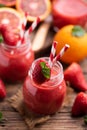 Strawberry smoothie in glass jar, over old wood table Royalty Free Stock Photo