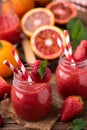 Strawberry smoothie in glass jar, over old wood table Royalty Free Stock Photo