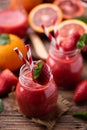 Strawberry smoothie in glass jar, over old wood table Royalty Free Stock Photo