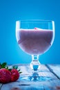 Strawberry smoothie in a glass with strawberry slices on top Royalty Free Stock Photo