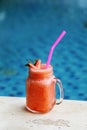 Strawberry Smoothie in jar beside swimming pool. Royalty Free Stock Photo