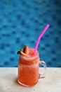 Strawberry Smoothie in jar beside swimming pool. Royalty Free Stock Photo