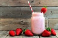 Strawberry smoothie in a mason jar over rustic wood Royalty Free Stock Photo