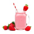 Strawberry smoothie in a mason jar with straw and berries over white