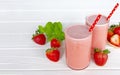 Strawberry smoothie or milkshake in jar, healthy food for breakfast and snack on white wood background.