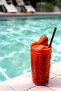 Strawberry smoothie by the swimming pool Royalty Free Stock Photo