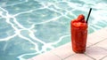 Strawberry smoothie by the swimming pool Royalty Free Stock Photo