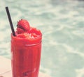 Strawberry smoothie by the swimming pool Royalty Free Stock Photo