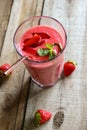 Strawberry smoothie in a tall glass with metal straws