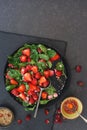 Strawberry Spinach Salad with sesame seeds and rose petals