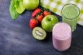 Strawberry and spinash smoothies in glasses with ingredients