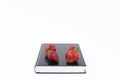 Strawberry. Strawberries on a book. Concept. Holy Bible. On a white background. Book on the table Royalty Free Stock Photo