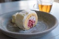 Strawberry swiss cream roll cake in dish with whipped cream. Royalty Free Stock Photo