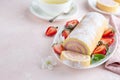 Strawberry swiss roll cake on white plate