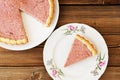 Strawberry tart with cut out piece on separate plate on old wood