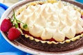 Strawberry tart with meringue on brown plate. Royalty Free Stock Photo