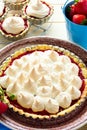 Strawberry tart with meringue on brown plate. Royalty Free Stock Photo