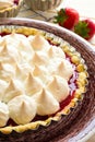 Strawberry tart with meringue on brown plate. Royalty Free Stock Photo