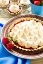 Strawberry tart with meringue on brown plate. Royalty Free Stock Photo