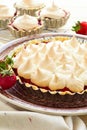 Strawberry tart with meringue on brown plate. Royalty Free Stock Photo