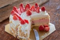 Strawberry And Vanila Ice Cream Cake With Fresh Strawberry Topping On Wooden Table