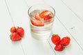 Strawberry water on a light white table. Detox, a healthy lifestyle. Fresh drink
