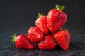 Strawberry. Wet ripe strawberry on black background. Red berries with water drops. Selective focus Royalty Free Stock Photo