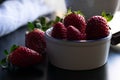 Strawberry white bowl photo with dark background Royalty Free Stock Photo