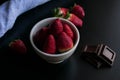 Strawberry white bowl photo with dark background Royalty Free Stock Photo