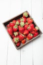 Strawberry wooden box on white wooden background