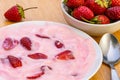 Strawberry yoghurt with pieces of strawberry in white ceramic dish Royalty Free Stock Photo