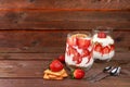 Strawberry yogurt with berries French cracker and muesli on a wooden table fruit salad. Healthy breakfast with ingredients